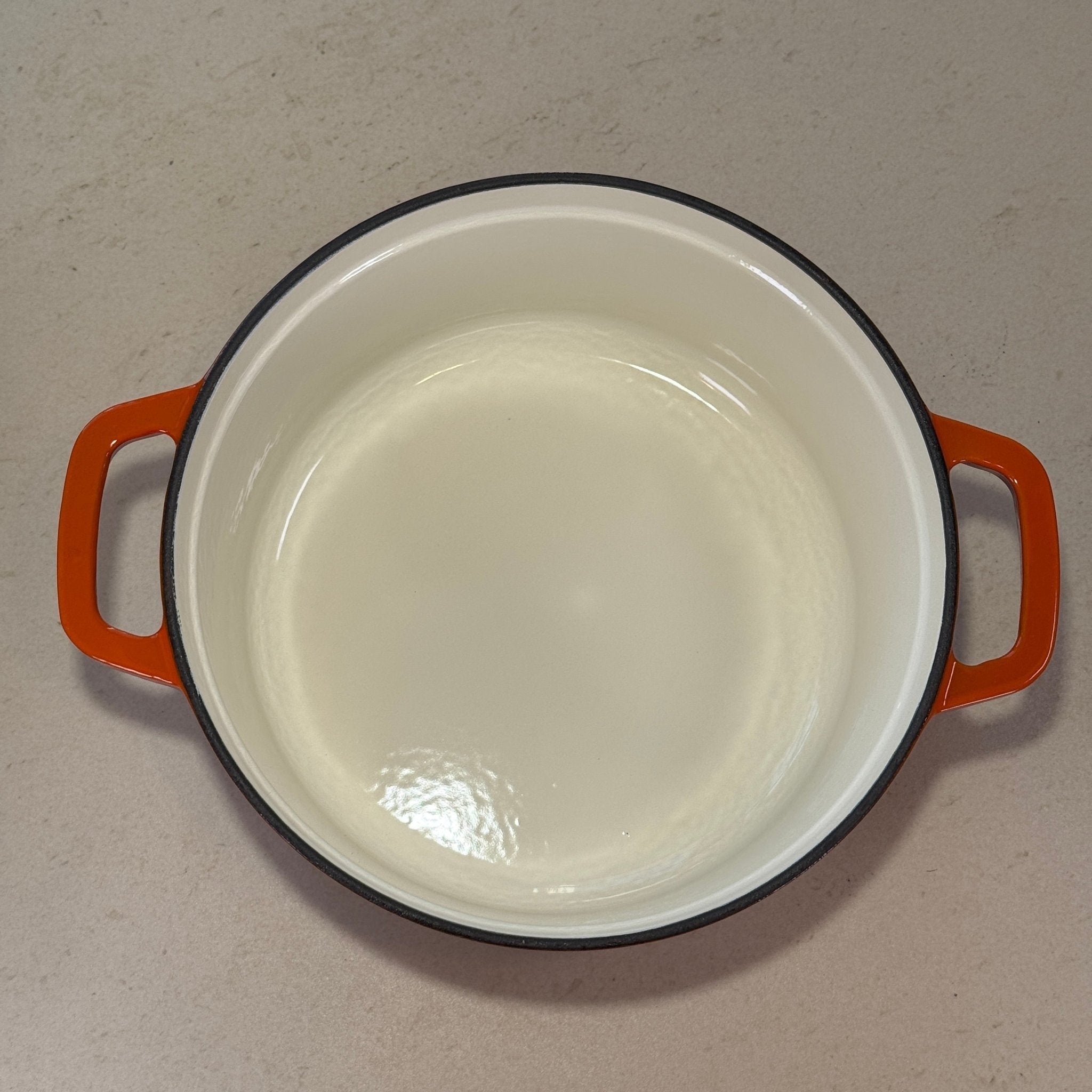 Intérieur anti adhésif clair d’une cocotte classique en fonte émaillée Orange pour cuisson homogène et facile à nettoyer