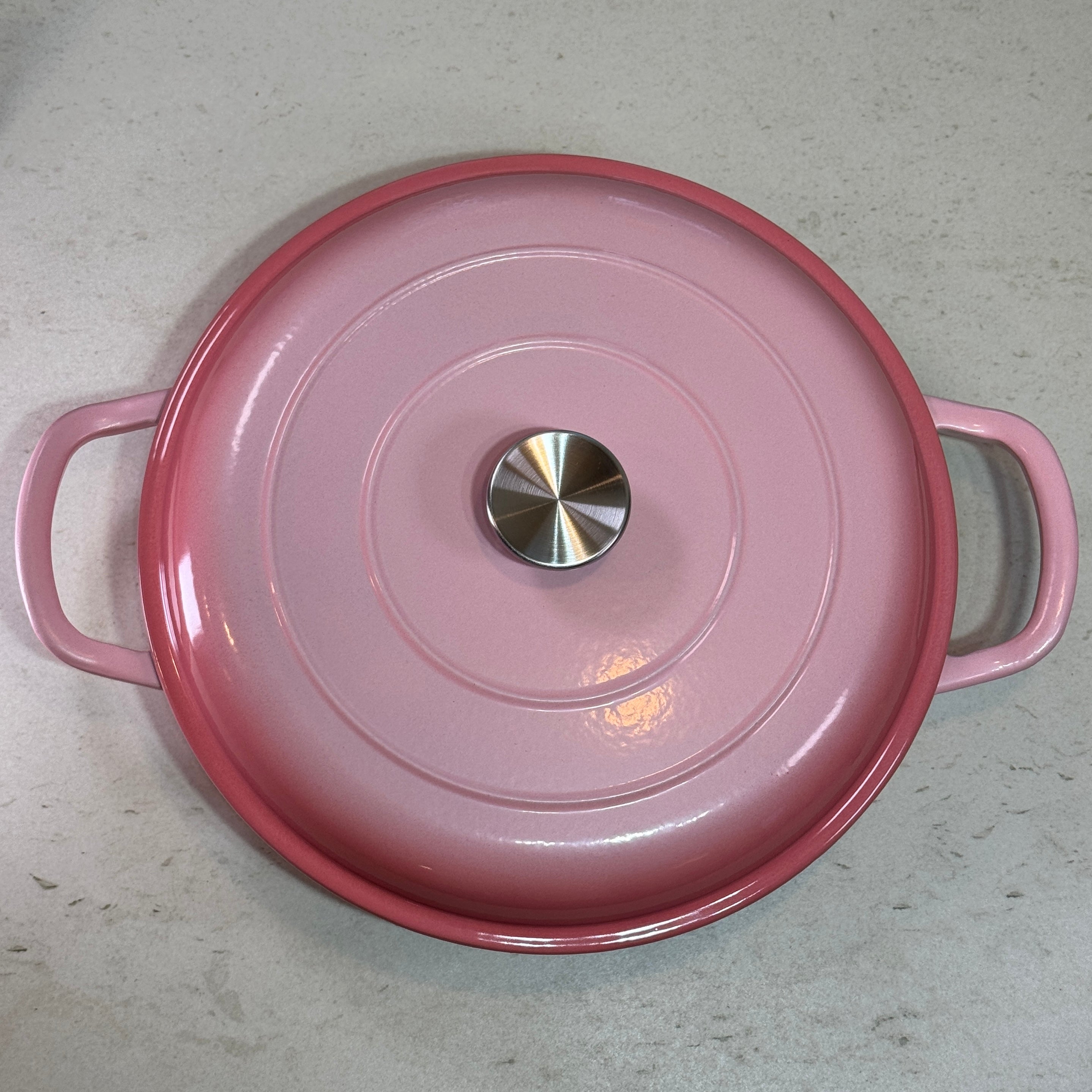 Faitout en fonte émaillée rose poudré avec couvercle à picots assurant un arrosage naturel des plats pendant la cuisson